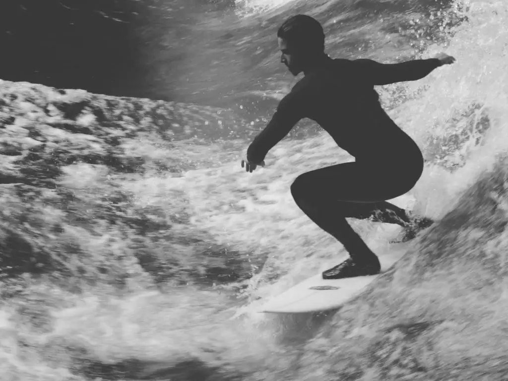 Surfer in a squatting position of his board