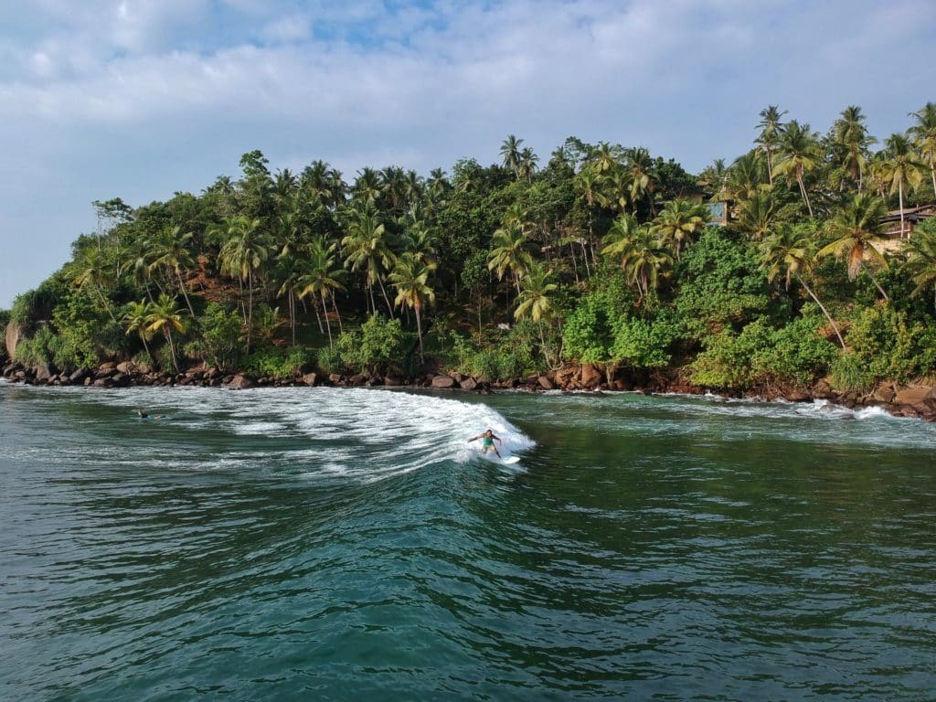 Surfer in a tropical scenery