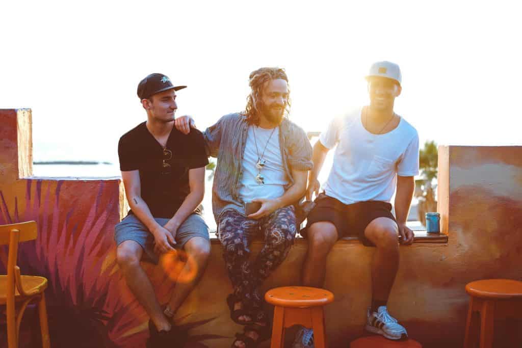 Three friends in Ericeira on a learn to surf trip