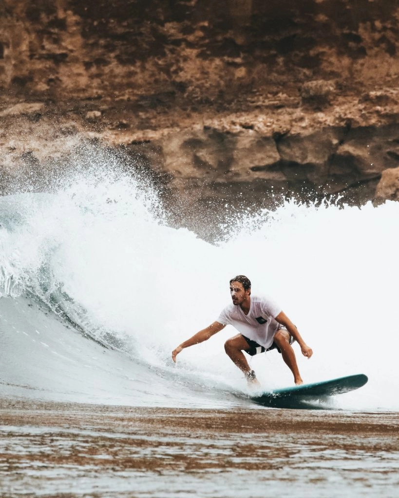 Beginner-surfer-riding-a-wave-819x1024-1-768x960