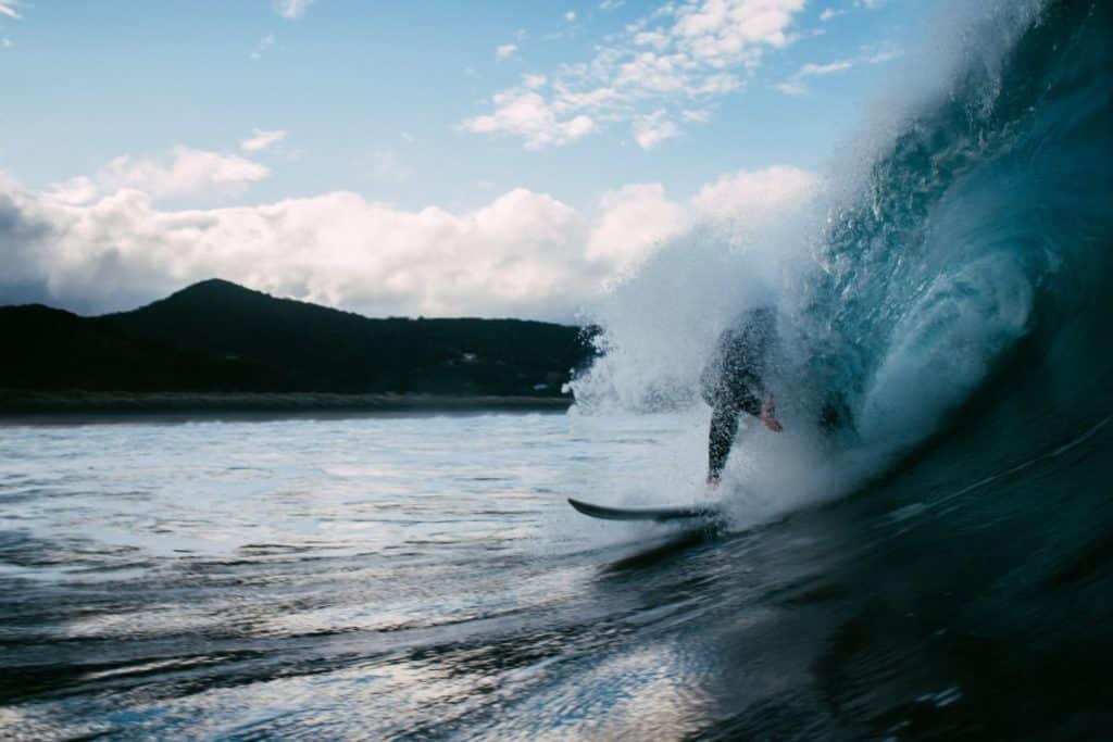 Surfer being hit by a wave on the head