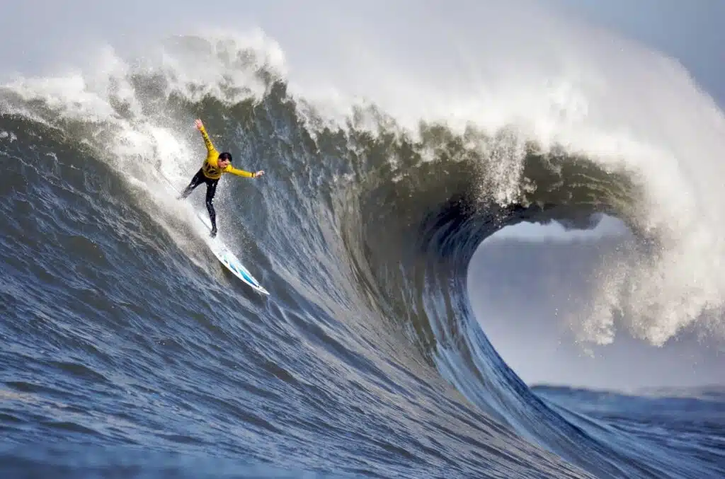 An image of a person surfing Mavericks, one of the highest waves in Northern California
