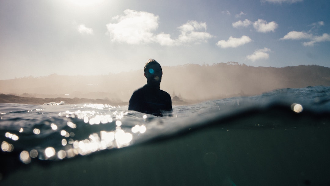 A surfer sitting in the lineup in Portugal