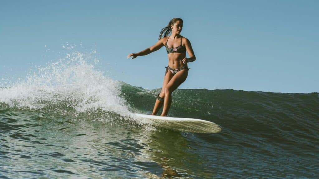 An image of an athletic female surfer surfing the waves