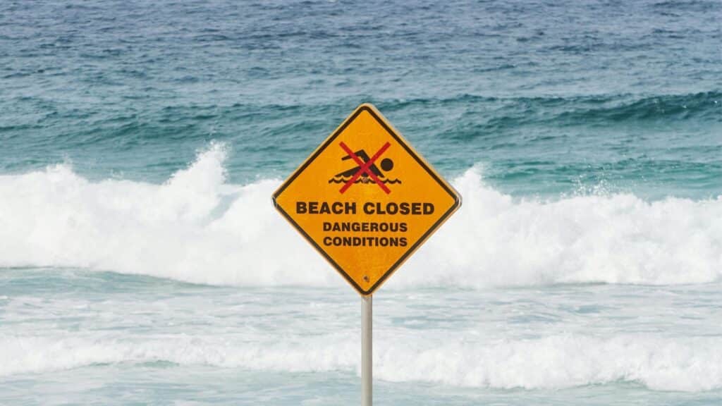 An image beach closed sign due to a high surf warning