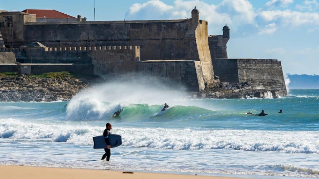 An image of bodyboarders at a beach