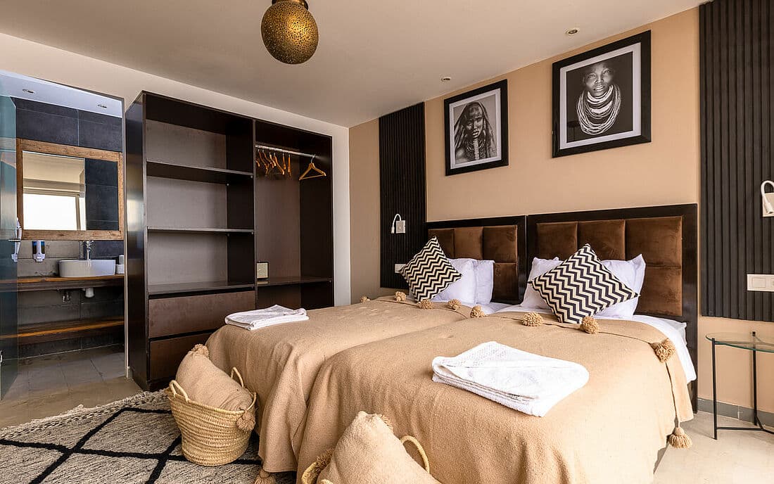 A room with twin beds decorated in beige tones