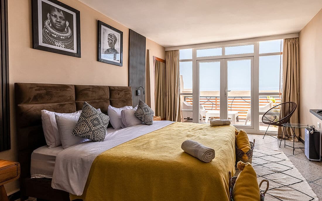 A room with a bed decorated in beige tones