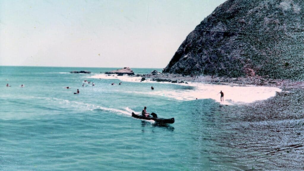 An image of surfers in the ocean at Dana Cove in July 1966. The image is courtesy of Orange county archives