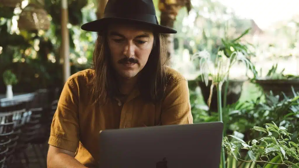 Digital nomad in Bali working before surfing