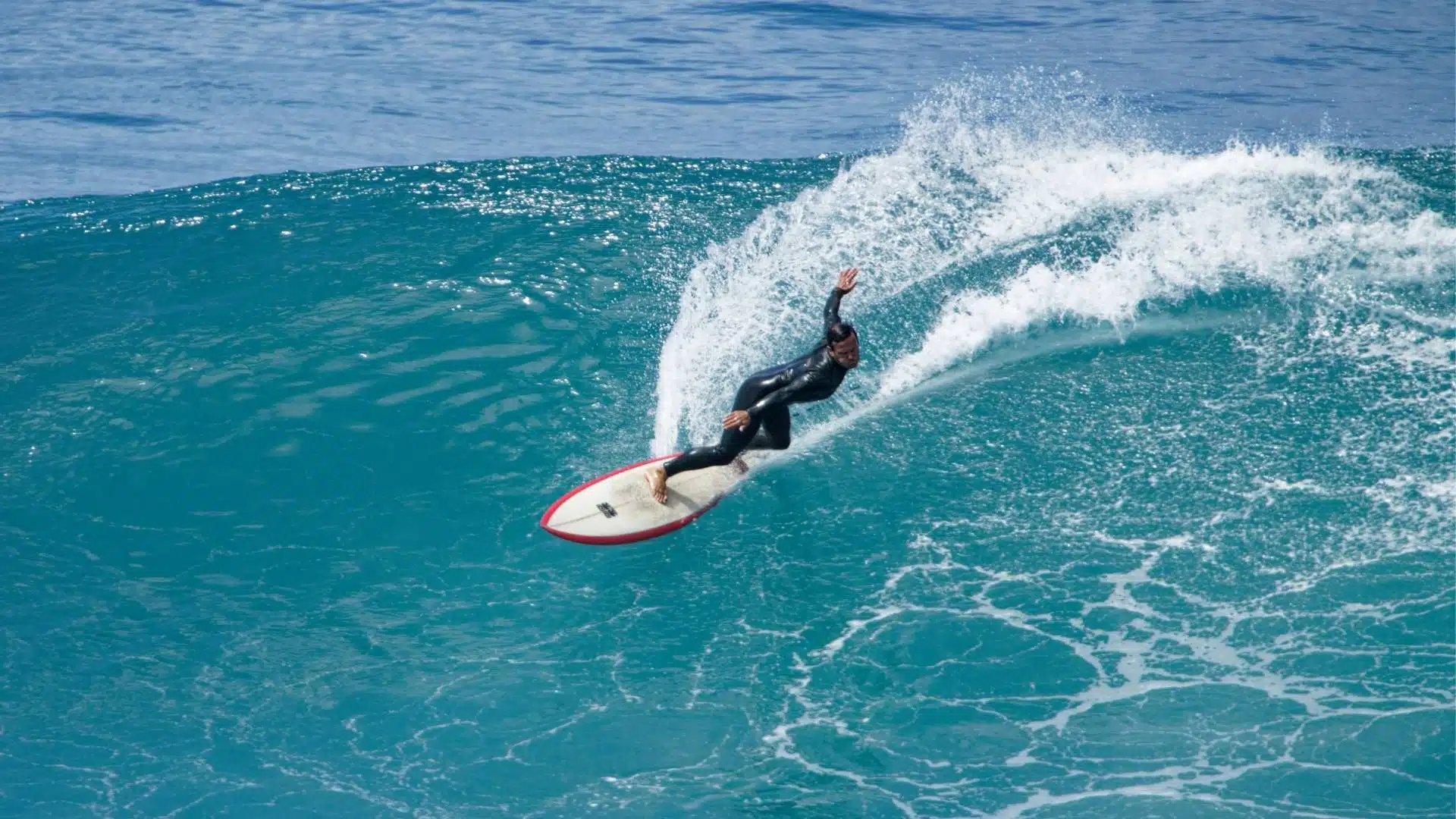 An image of a surfer going fast on a wave
