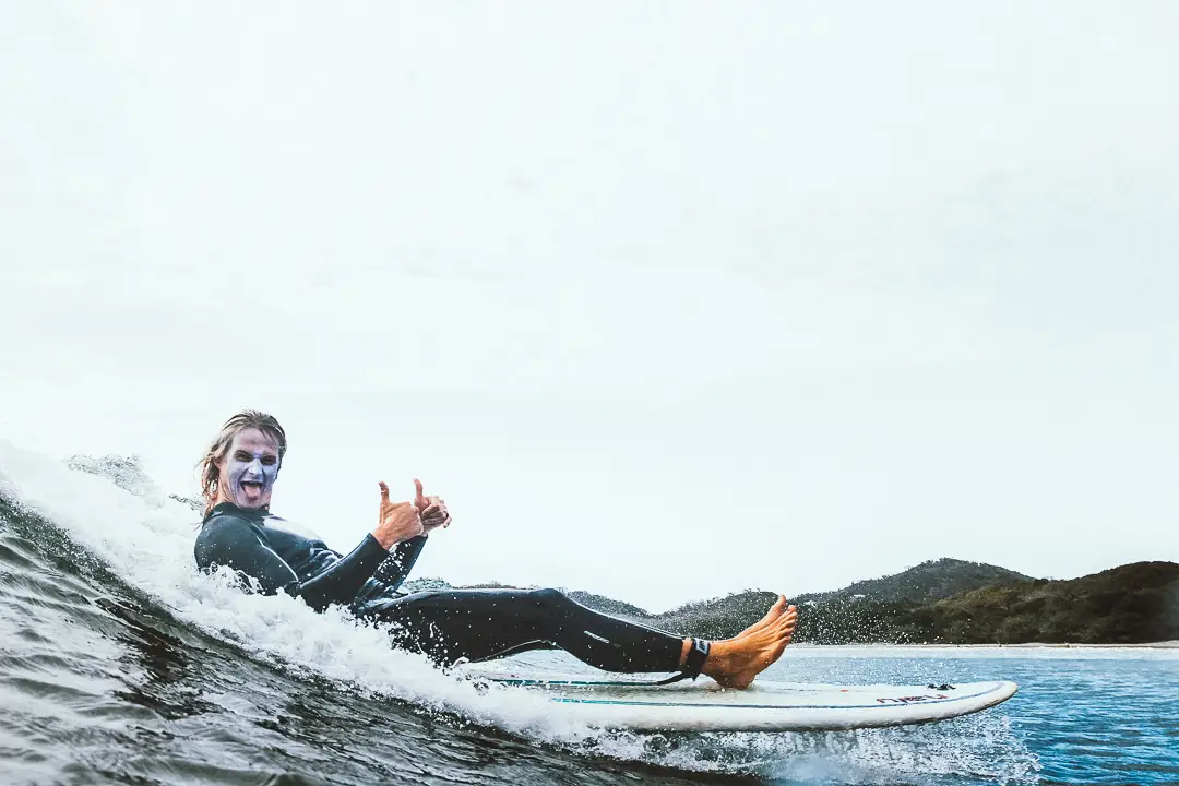 Happy surfer riding wave in Nicaragua