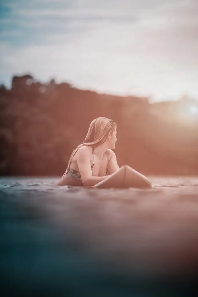 Girl on surfboard waiting for wave