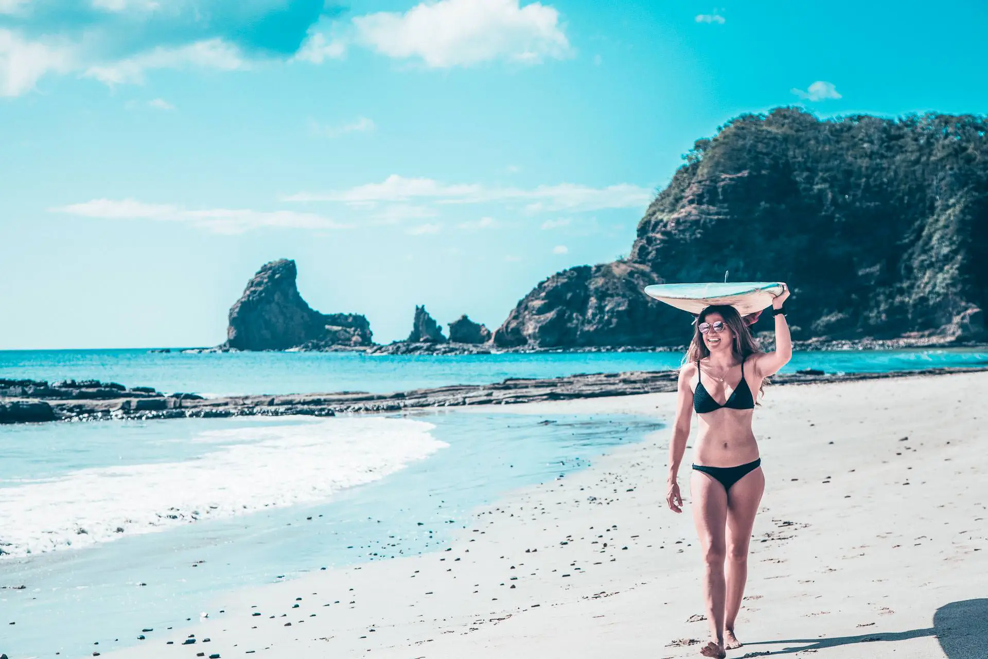 Girl walking to the surf in Nicaragua Maderas