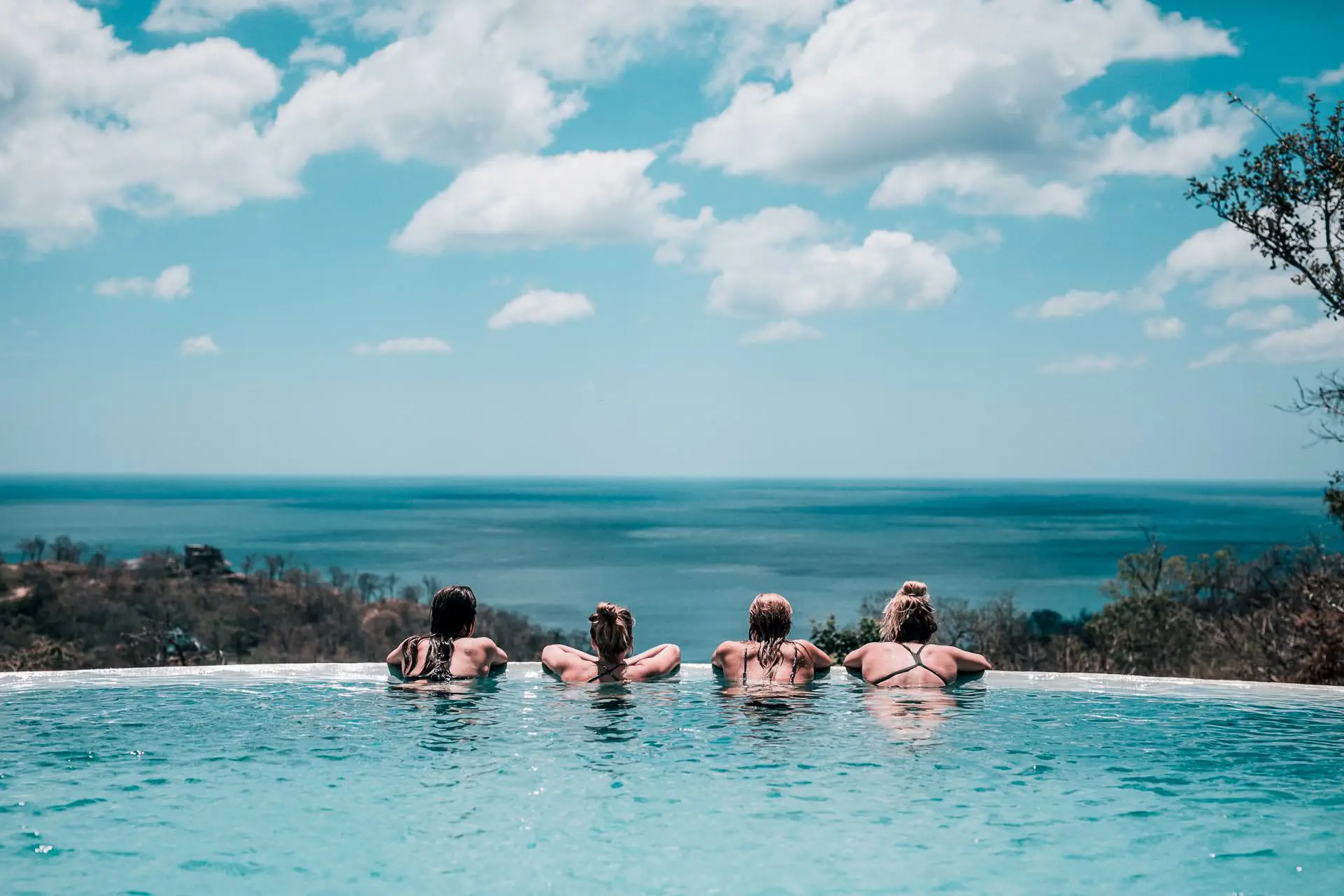 Girls watching the surf from our infinity pool at Rapture Surfcamp Nicaragua