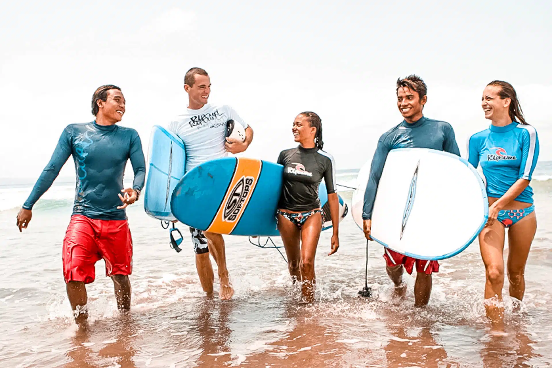 Group of People walking with Surfboards