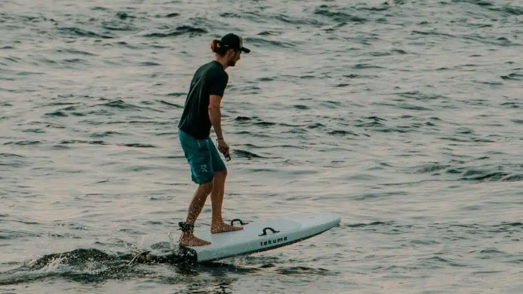 An image of a surfer foil surfing in the ocean