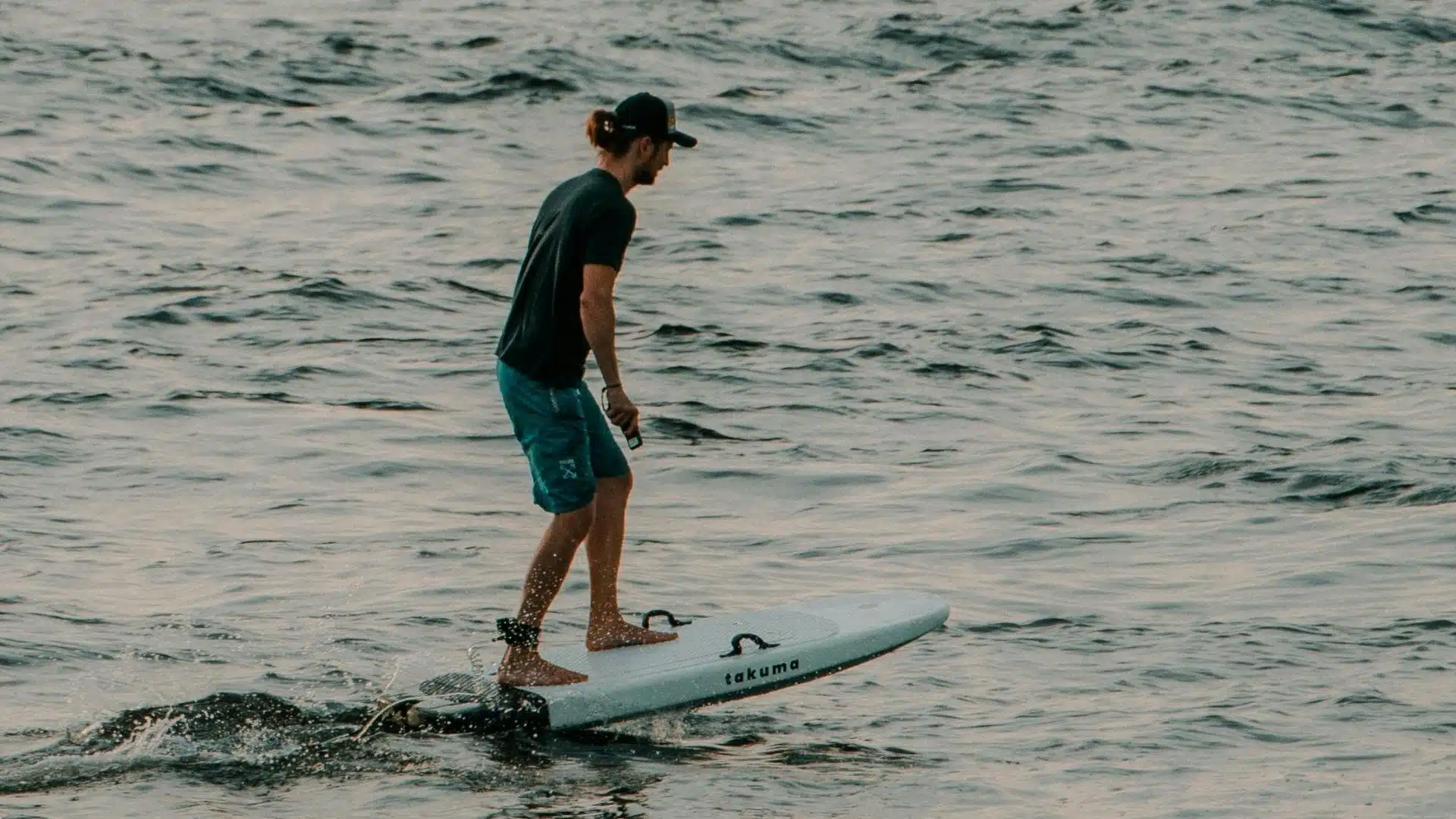 An image of a surfer foil surfing in the ocean