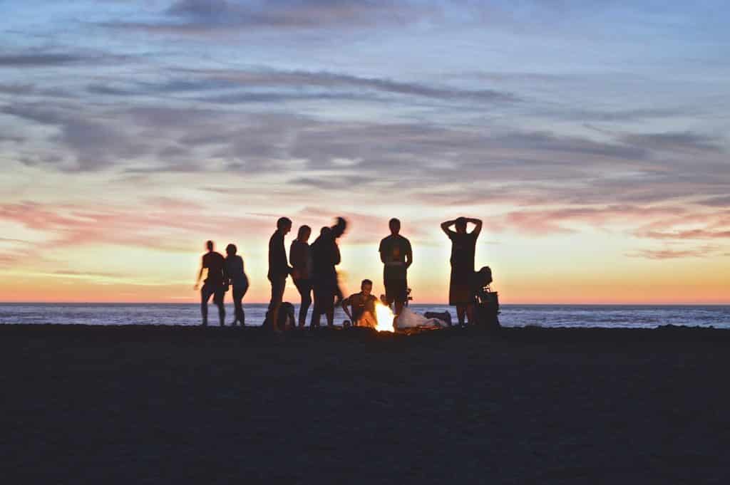 People on the beach at a surf camp