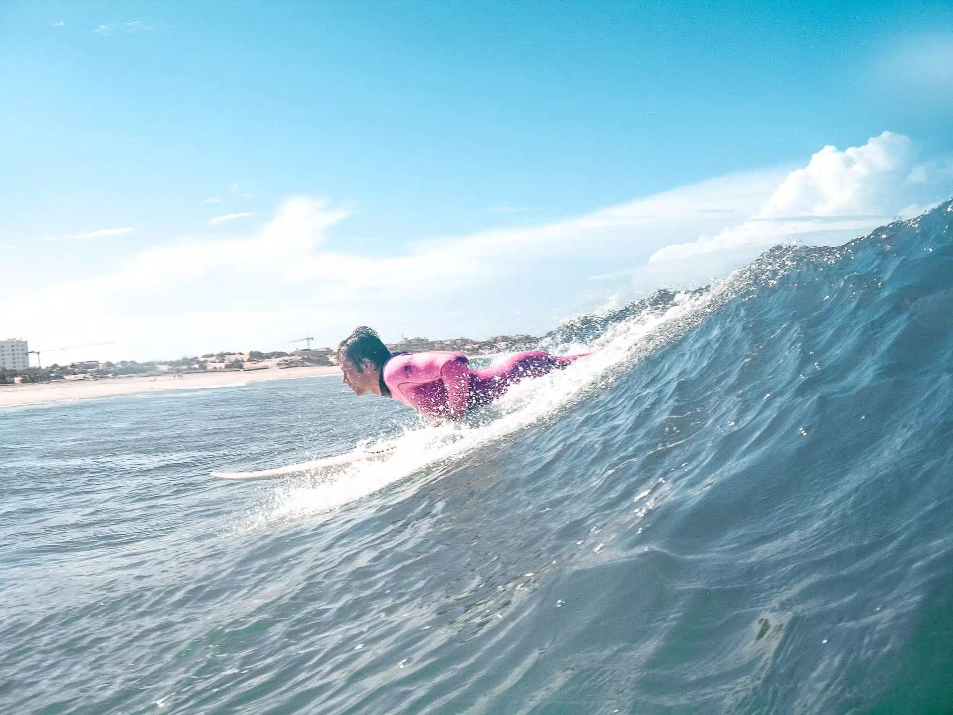 Surfer lying down on surf board