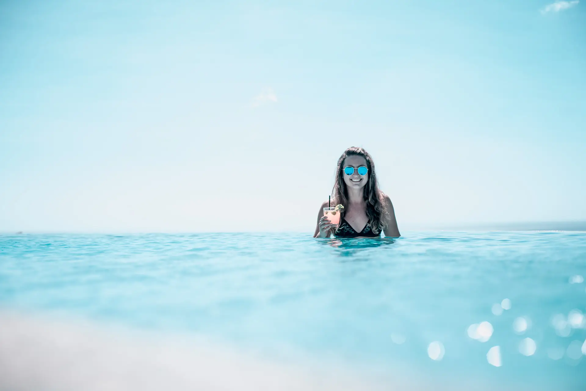 Girl having a drink at our infinity pool in Nicaragua Maderas
