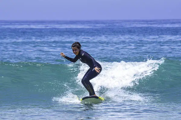 Girl standing on a surfboard