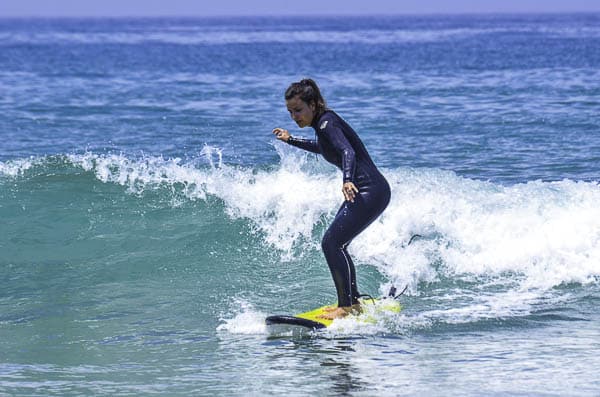 Girl standing on a surf board