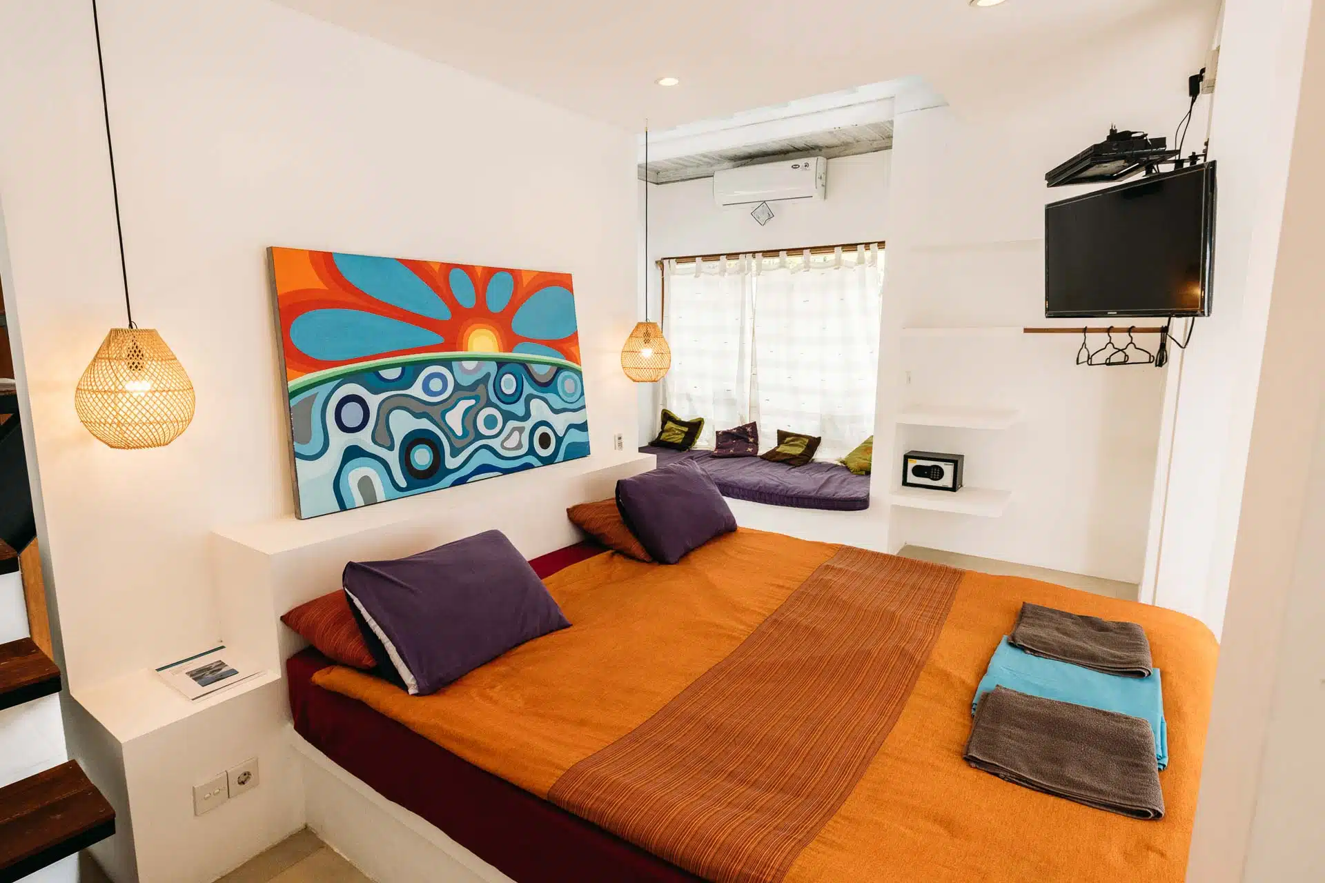 Bed in hotel and side sofa sunset inspiration in orange tones