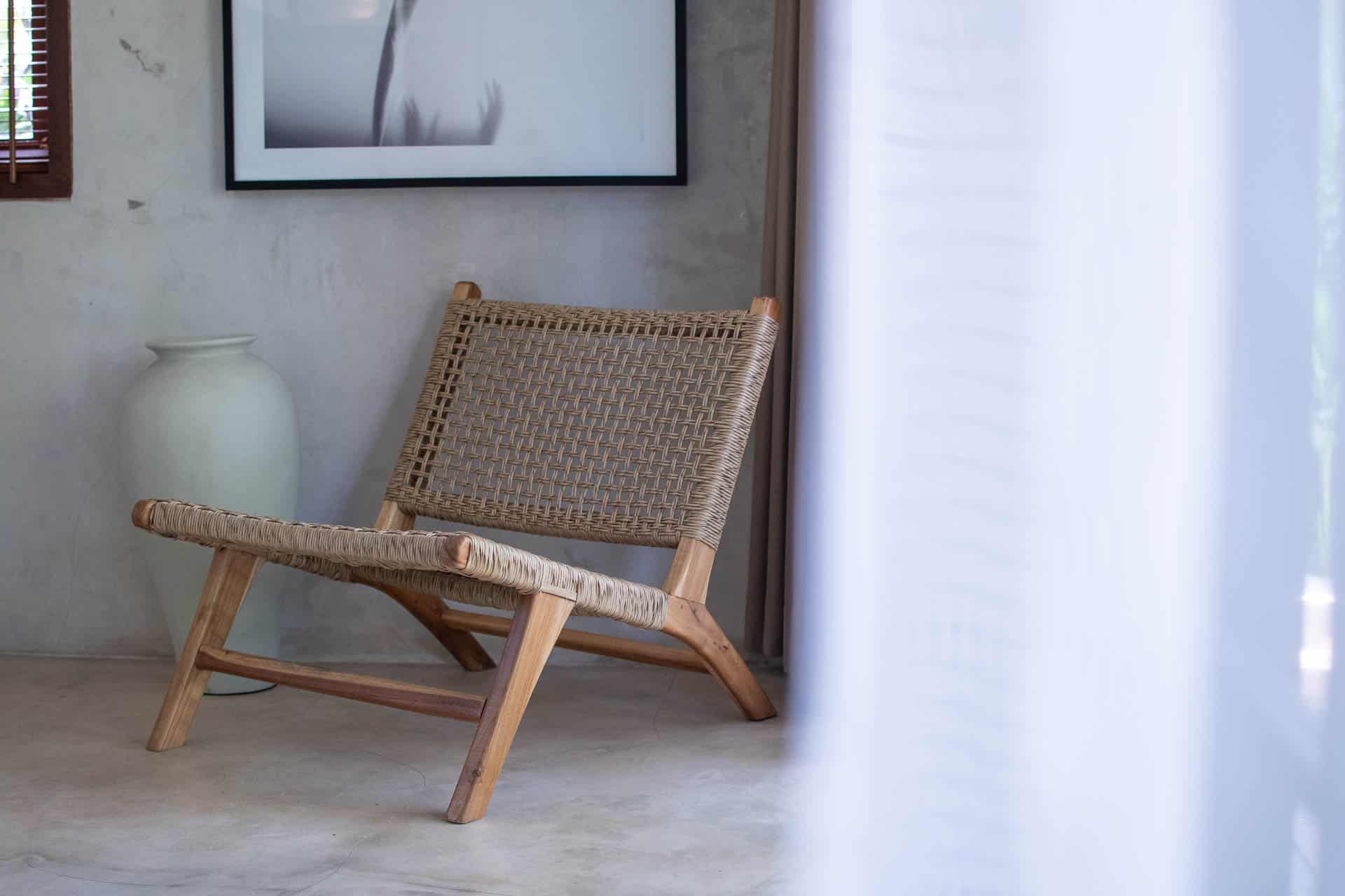 white chair and grey bean bag in hotel room with ac