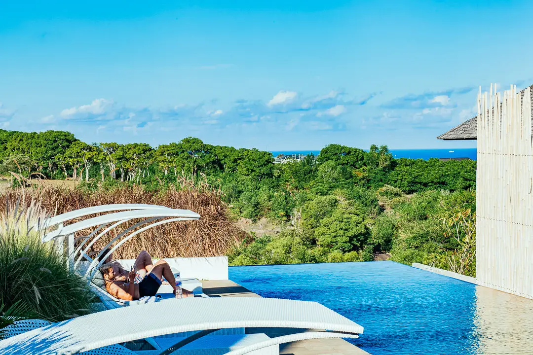 Guests relaxing by the infinity pool in Bali