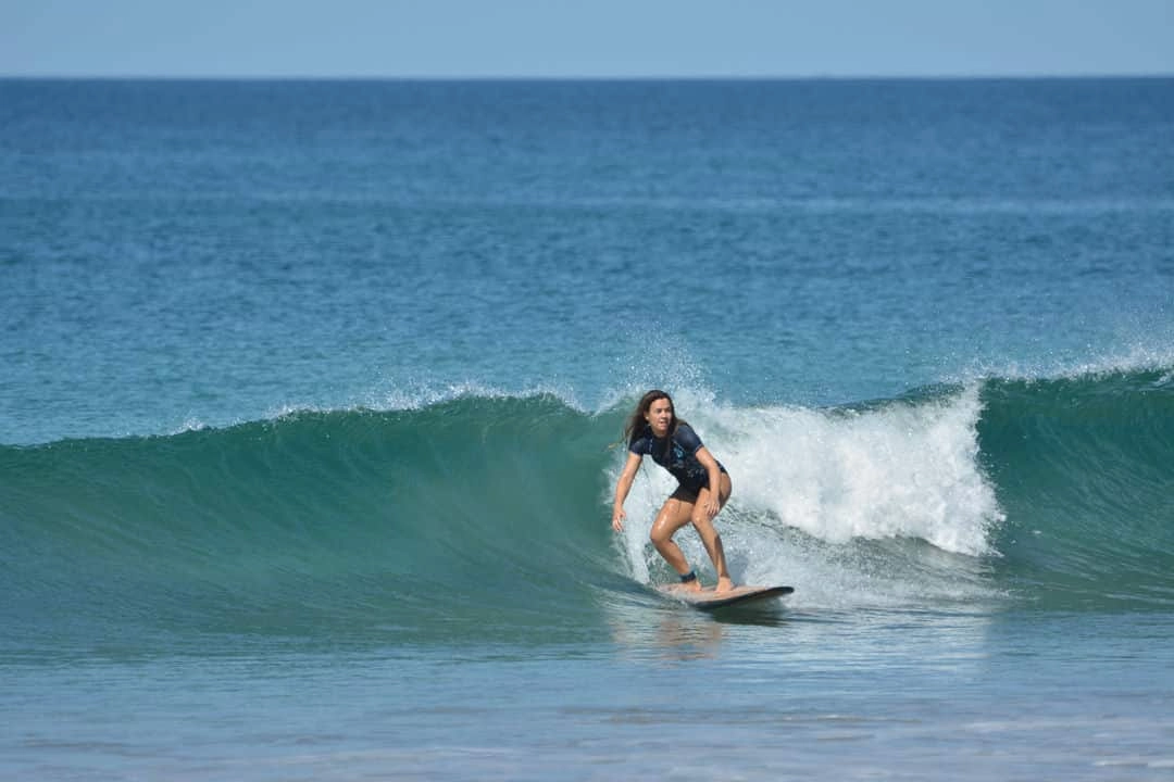 An old man surfing in costa rica