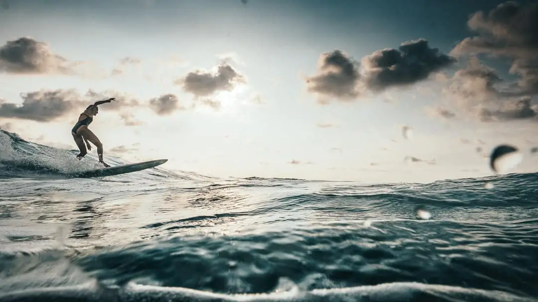 A girl surfing a begginer wave in cosra rica