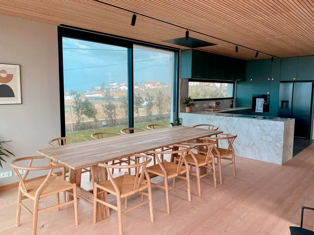 Rapture Surfcamps Ericeira Coxos sitting area wooden table