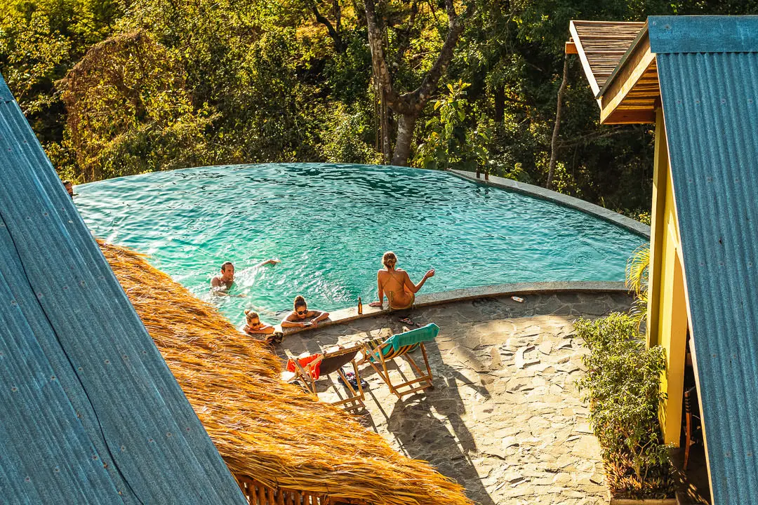Group of people relaxing at pool and garden