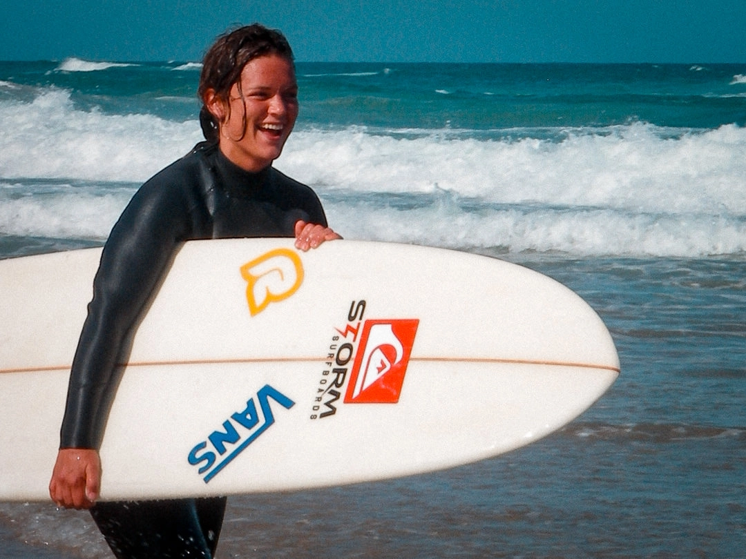 Beginner surfers with boards on the beach