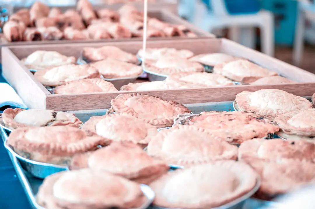 Several little portuguese meat pies in a tray
