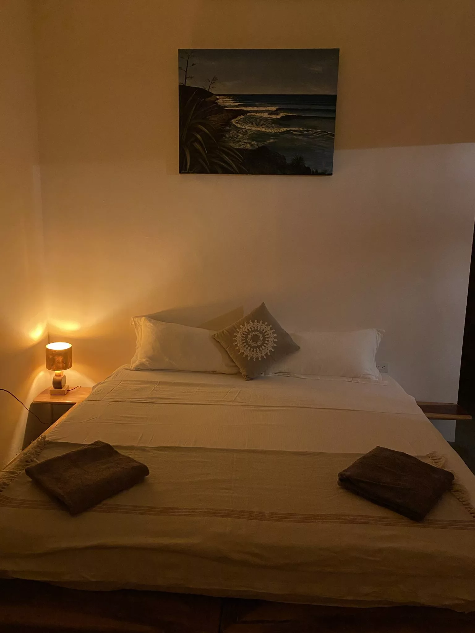 A bed in surf resort with light open at night