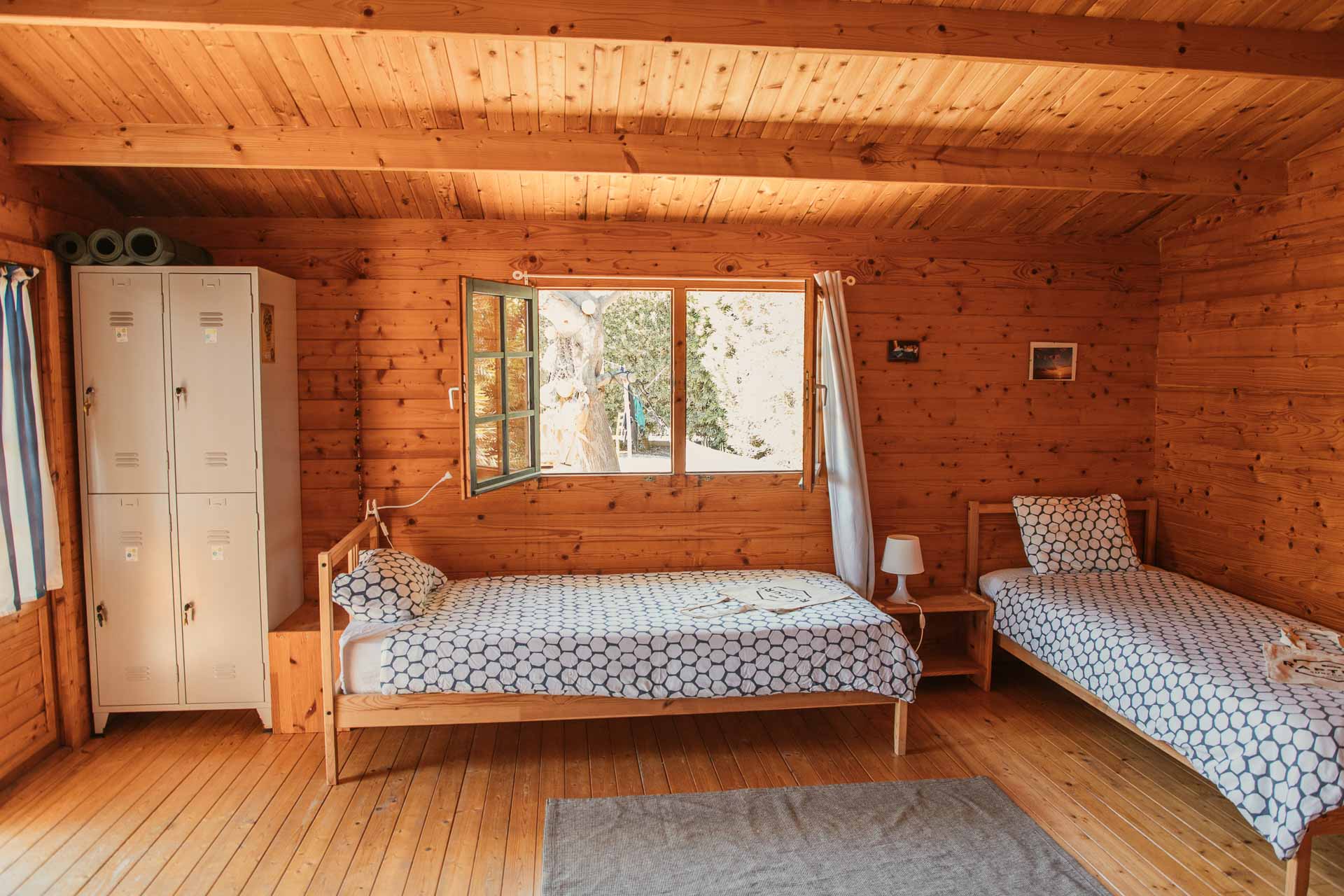 rustic cottage with lockers and single beds