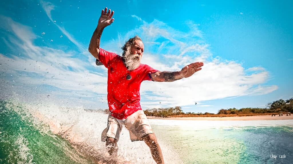 Senior surfer enjoying riding the waves.