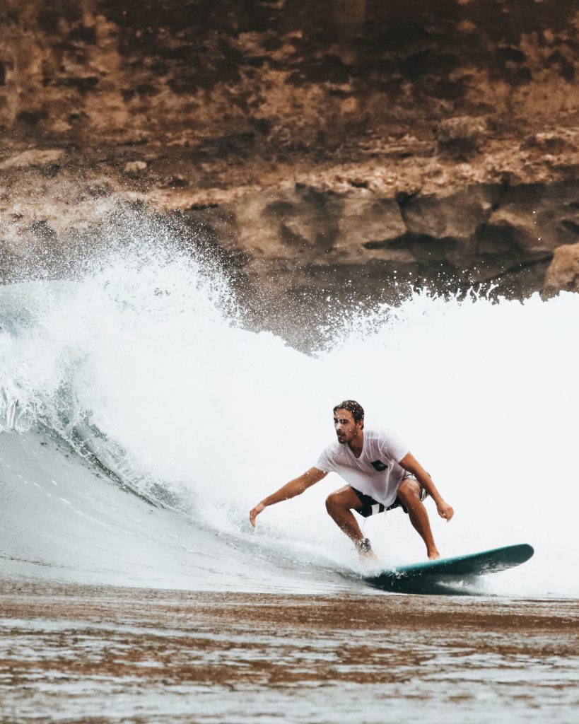 Surfer on a longboard dropping down a wave