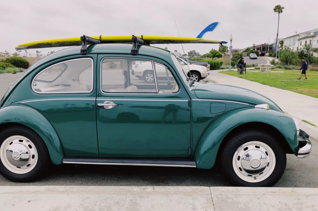Surfboard tied to the roof of a car