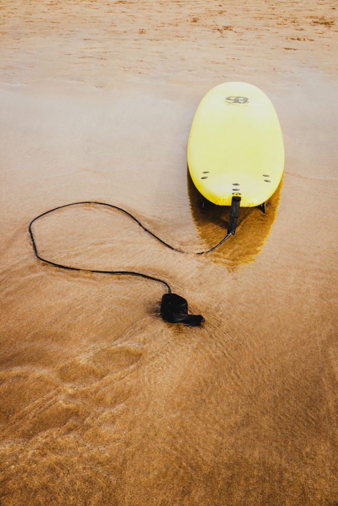 A yellow beginner's surfboard