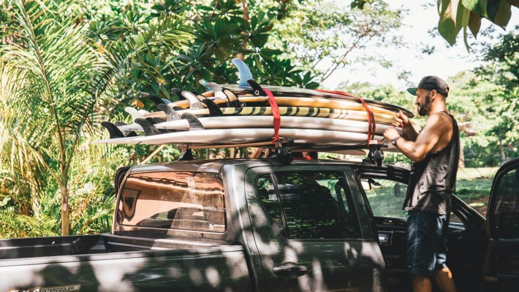 An image of surfboards on top of a pickup truck