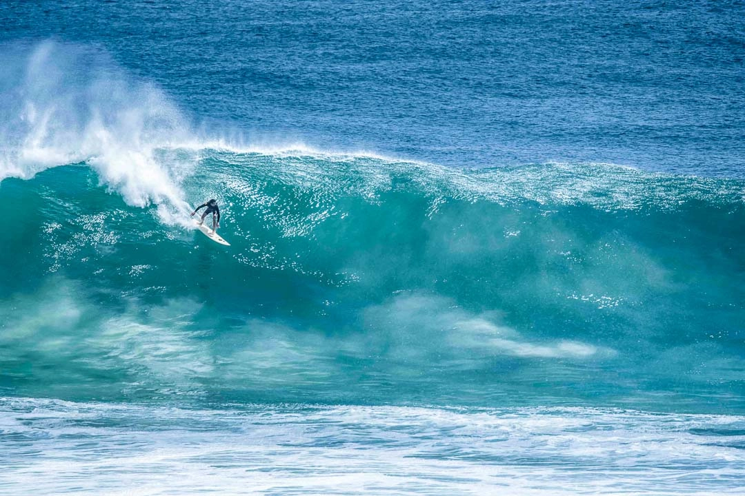 A Surfer riding a big wave in Bali
