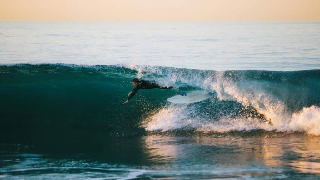 An image of a surfer falling off a surfboard