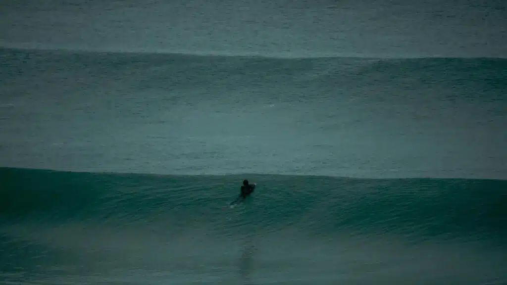 An image of a surfer on an ocean swell