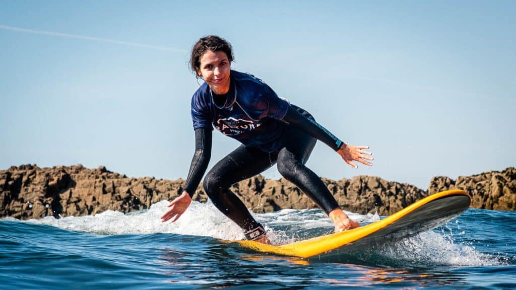 An image of a surfer on a yellow surfboard