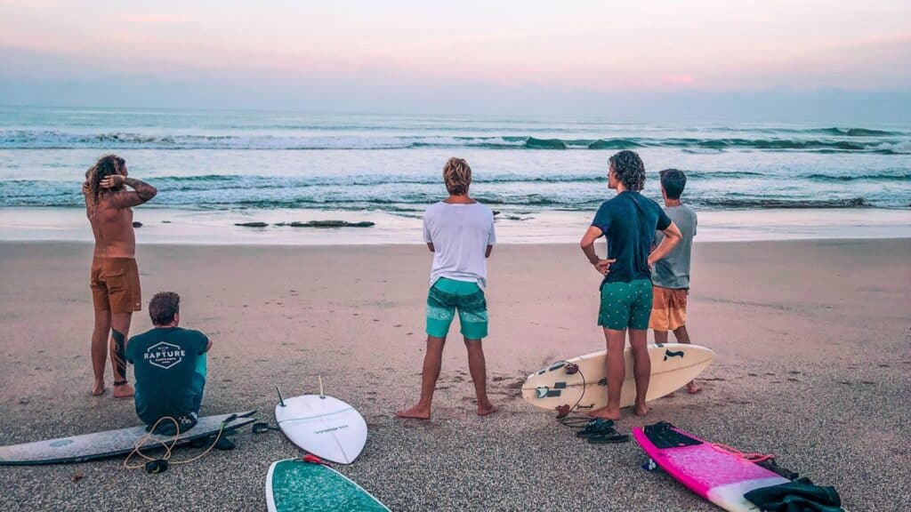 An image of surfers at the beach in Tamarindo
