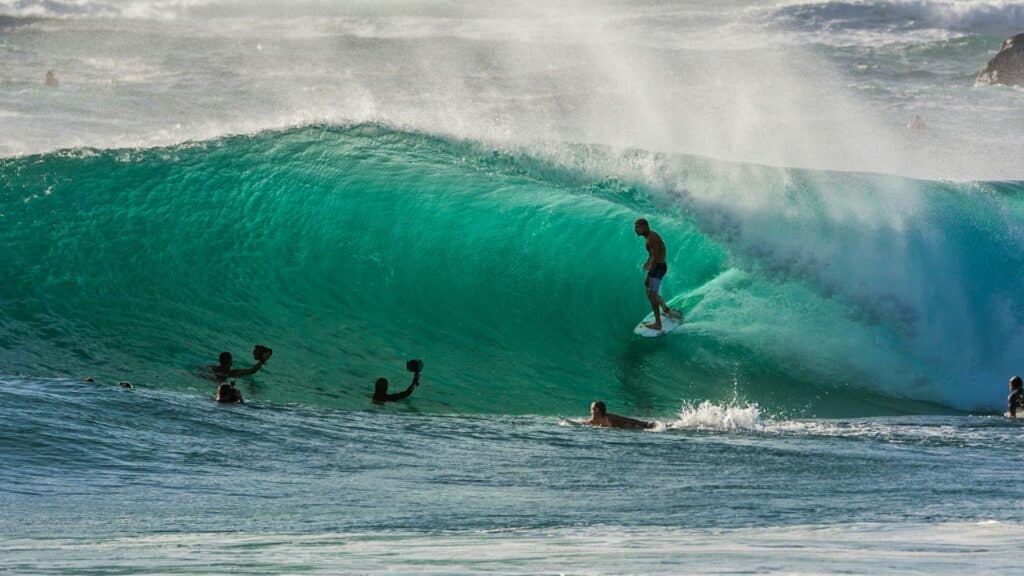 An image of a surfer surfing a tidal wave