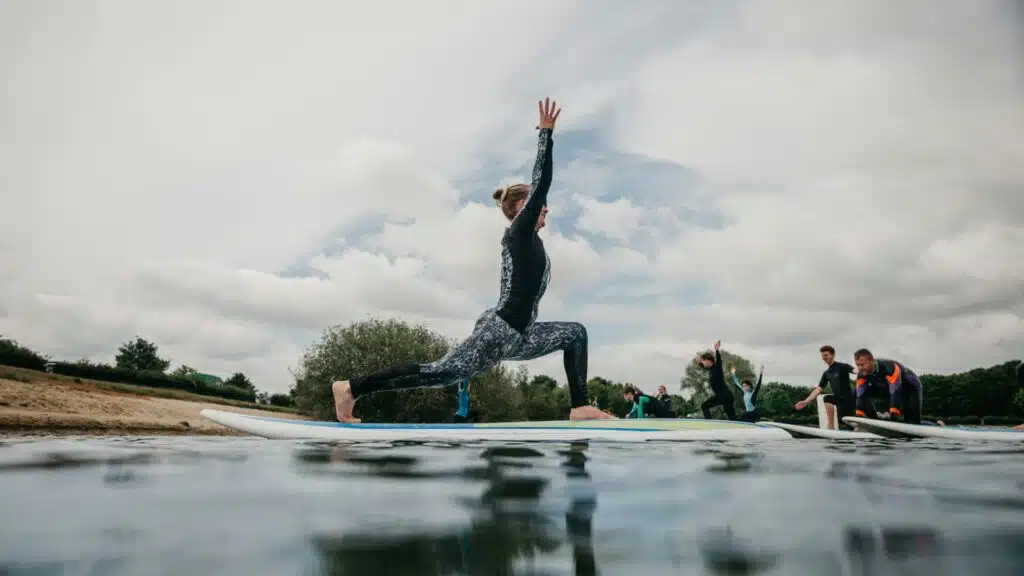 An image of surfers practicing yoga